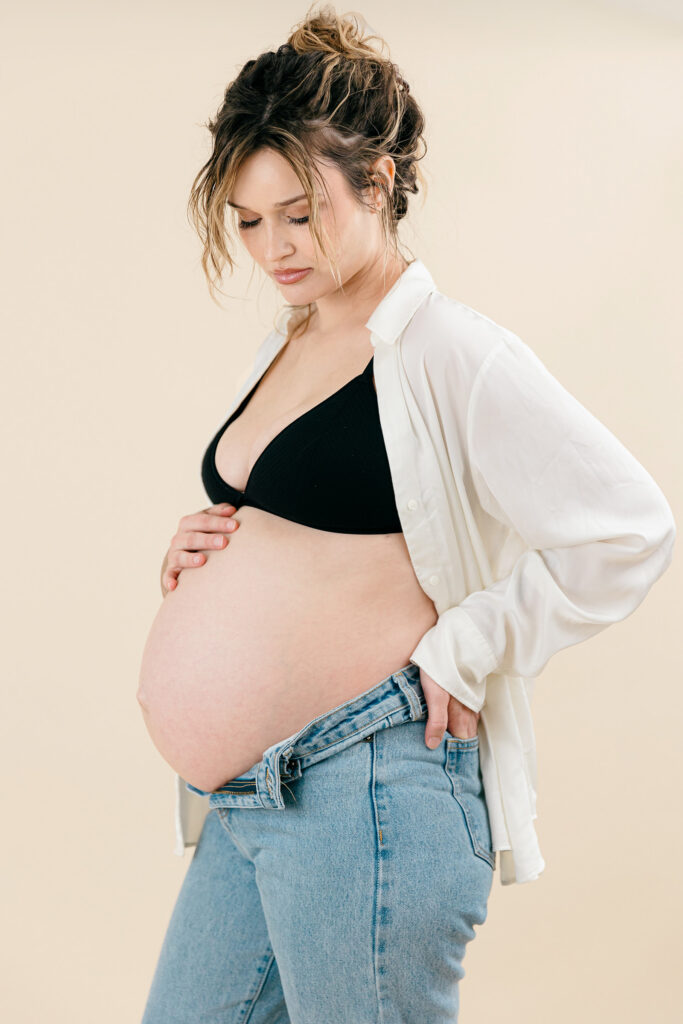 Timeless portrait of an expectant mother wearing a neutral maternity dress