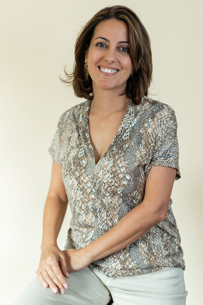 studio headshot of a woman smiling confidently at the camera - Boulder Portrait Photographer
