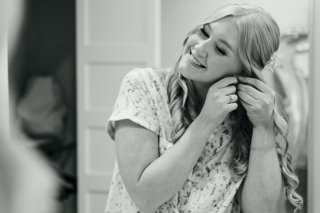 Bride putting on her earrings