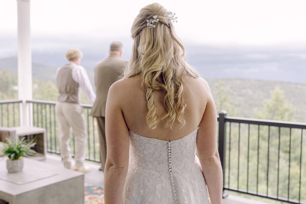 Bride walking toward her dad and brother for a first look