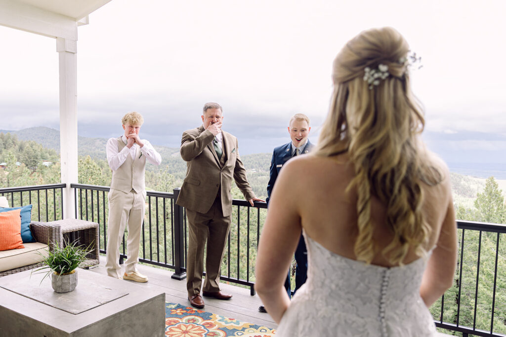 First look of the bride with her dad and brothers