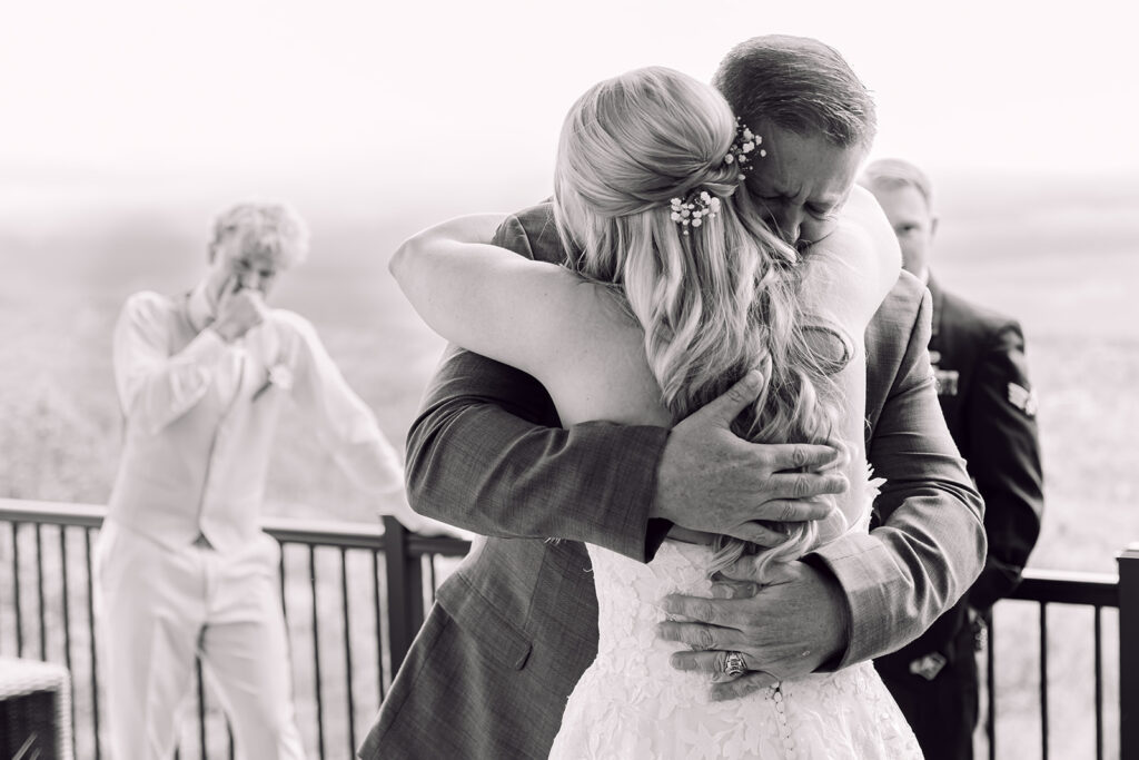Father of the bride hugging the bride
