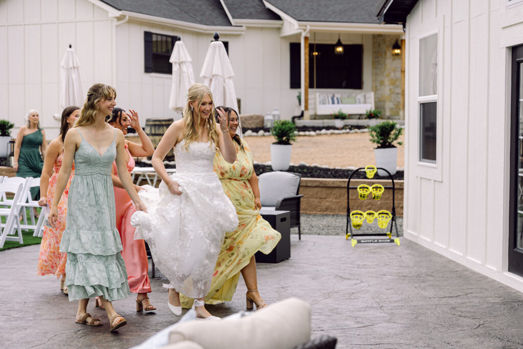 Bride and bridesmaid walking toward the groom