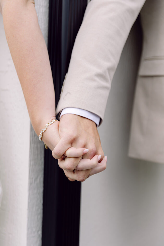 details of the hands at the first touch of the bride and groom