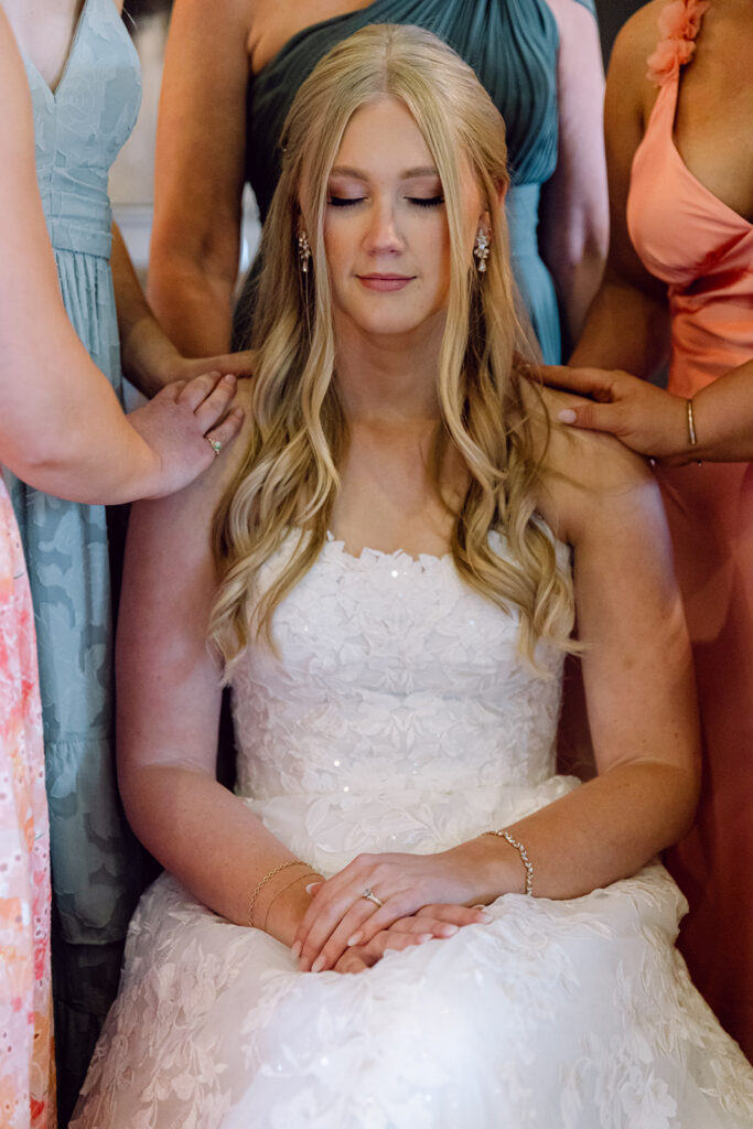 Prayers with bridesmaids before the ceremony