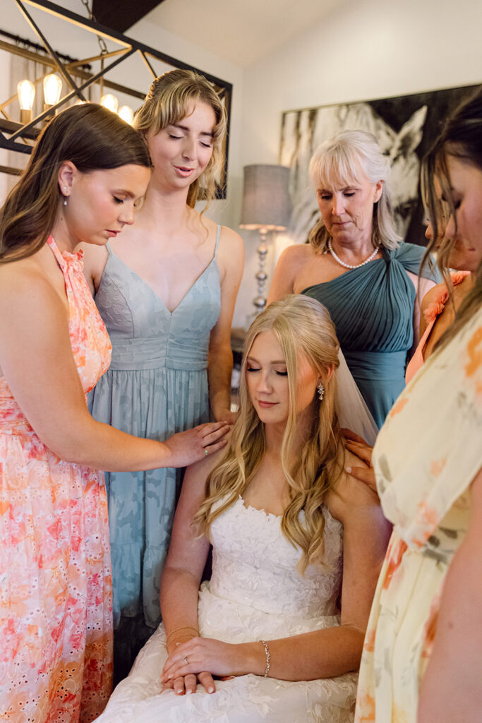 Each bridesmaids saying a prayer to the bride