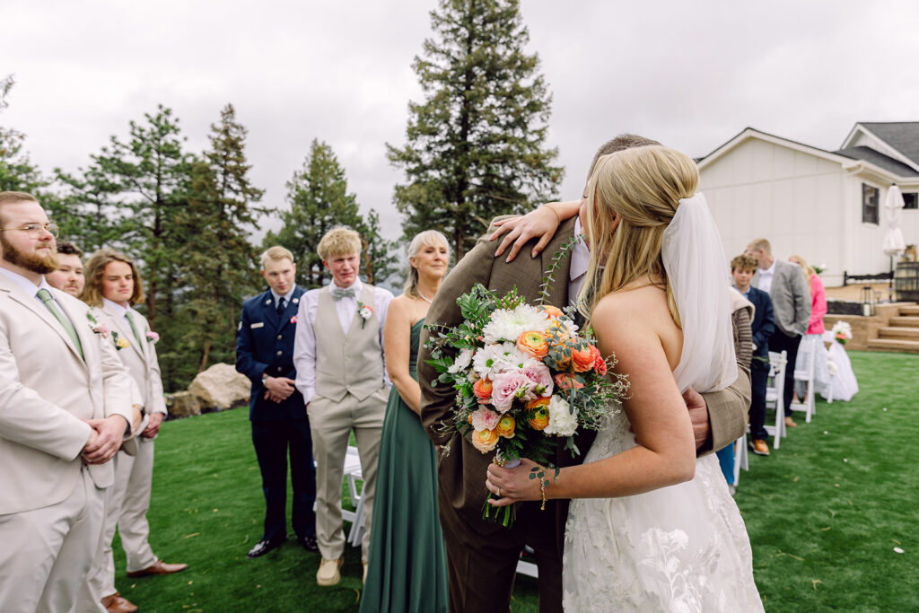 Bride hugging her father at the altar