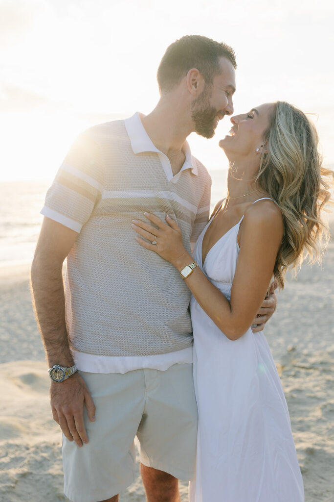 Engagement portrait at Sunset in San Diego, couple looking at each other smiling